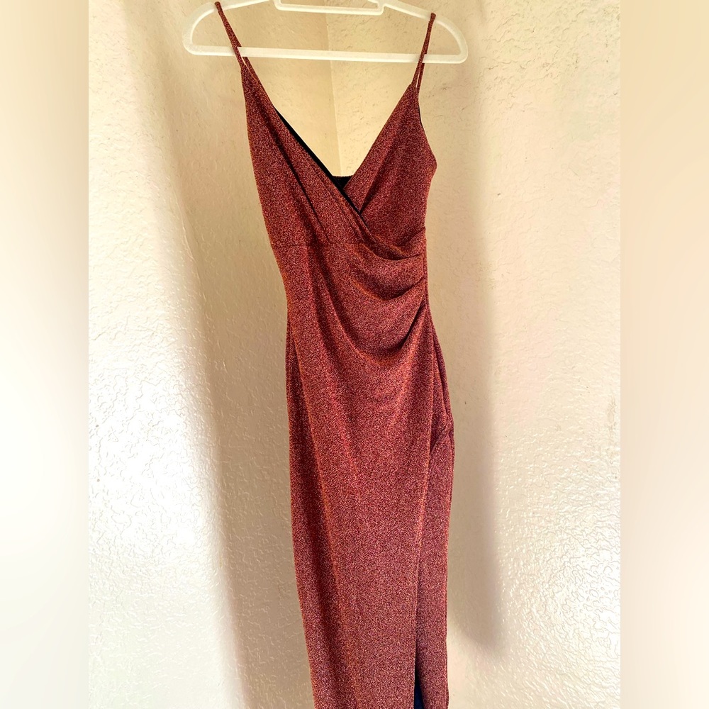 Beautiful knee-length, spaghetti strap dress with a slit from the thigh down.
